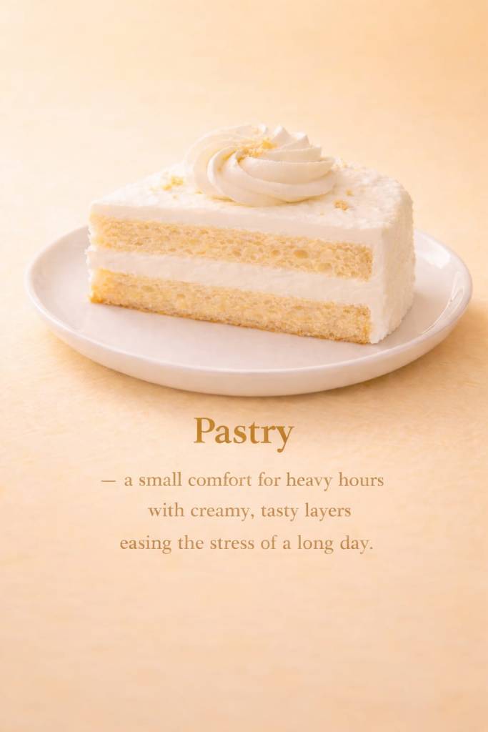 A slice of layered vanilla pastry with white cream frosting and a whipped topping swirl, placed on a white plate against a warm peach background.